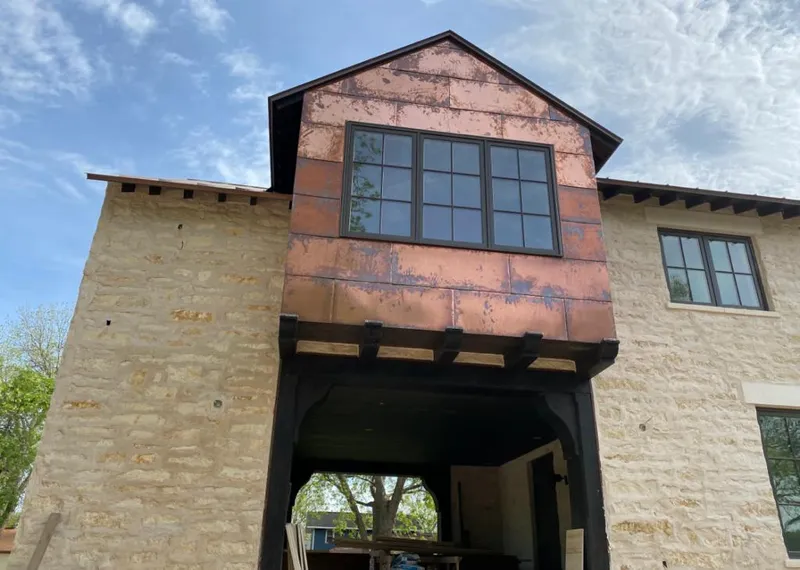 Copper metal panel facade on a stone building for Skylight Installation in Twin Falls