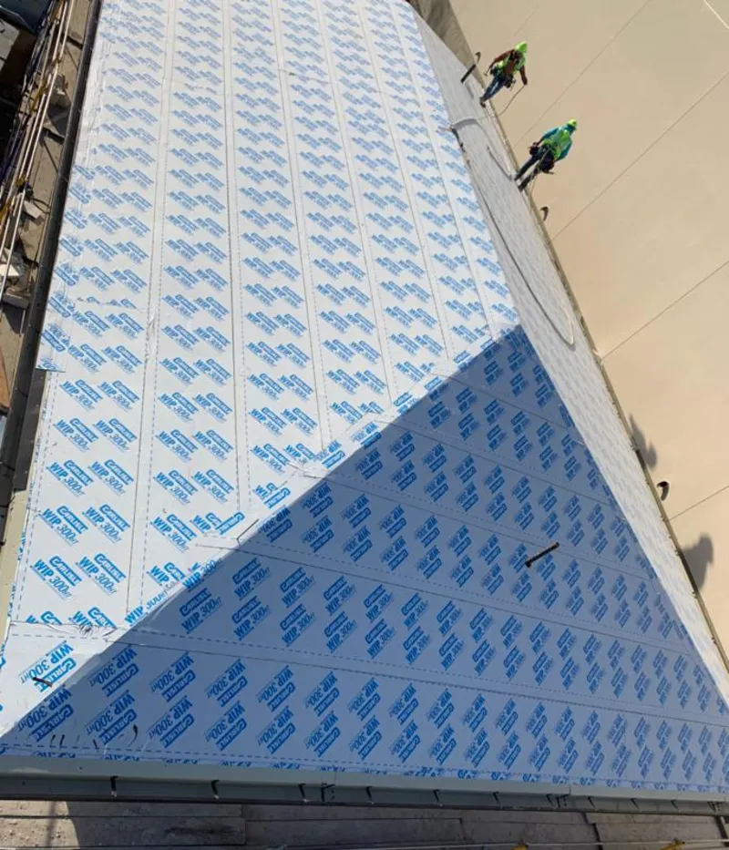 Professional roofers installing underlayment on a metal roof in Twin Falls